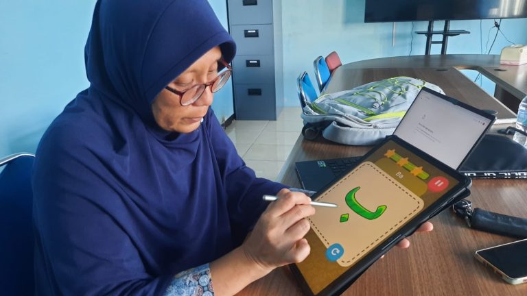 Dr Eng Nanik Suciati mempraktikkan menggunakan aplikasi Pembelajaran huruf Hijaiyah yang dikembangkan.